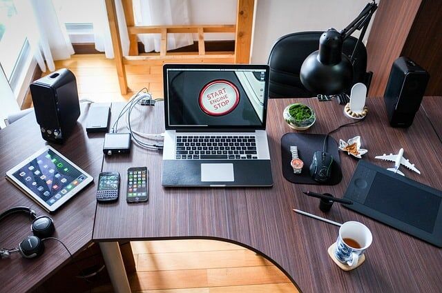 laptop and other phones on an office desk