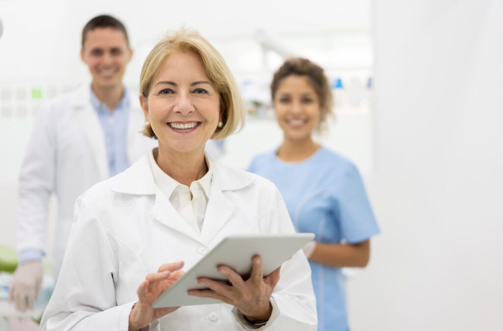 a female doctor is smiling while holding a tablet