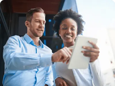 man and woman looking at notebook