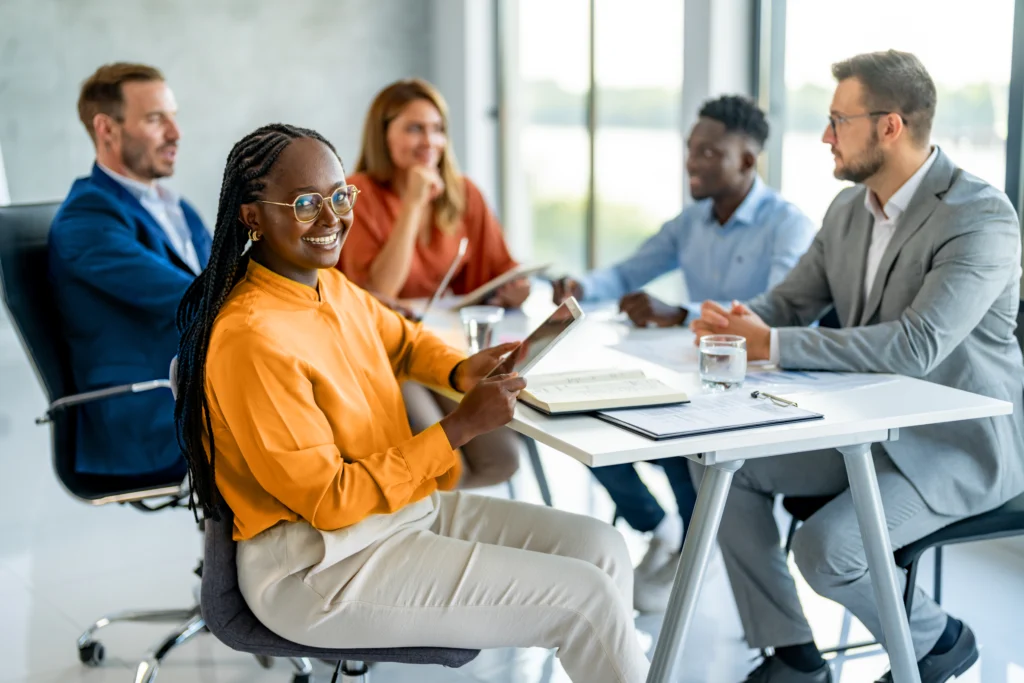 A photo of a group of diverse people in an office meeting.