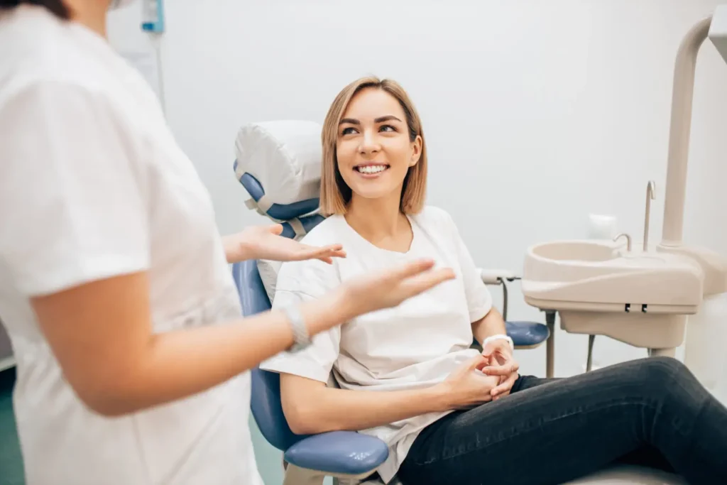 Dentist patient in chair talking to dentist