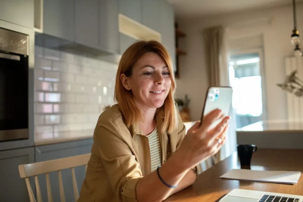 Woman looking at phone and smiling