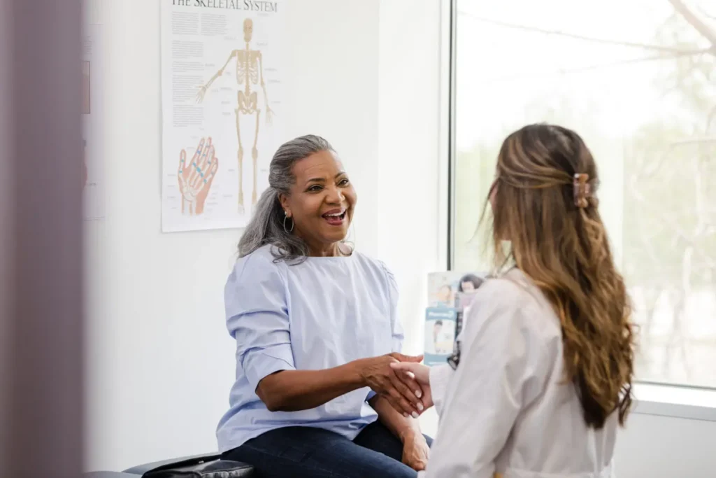 Woman patient shaking hands with doctor