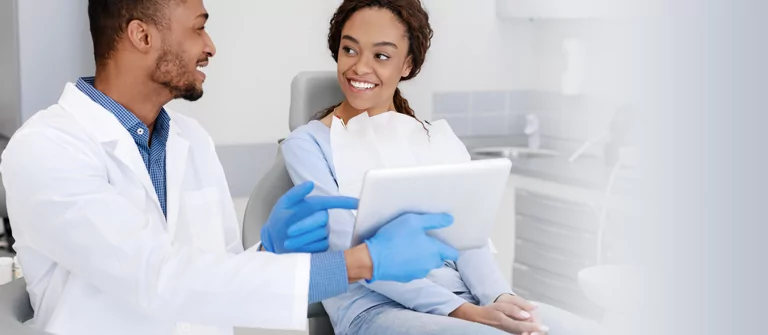 Dentist showing patient results on tablet