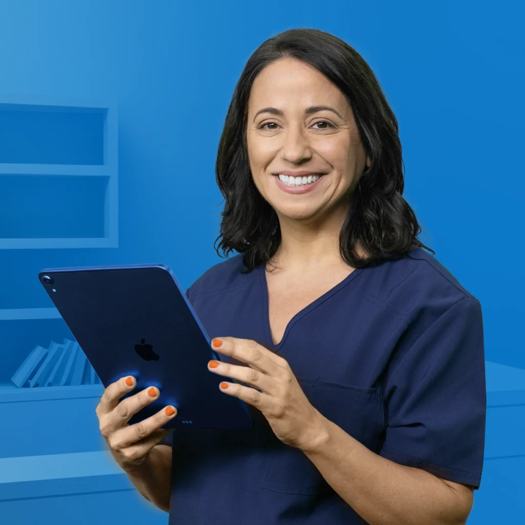 A photo of a female office manager in scrubs using a tablet computer.