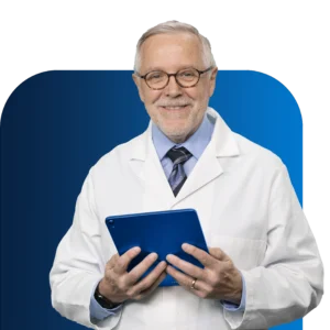 A photo of a male doctor smiling with table computer in his hands.